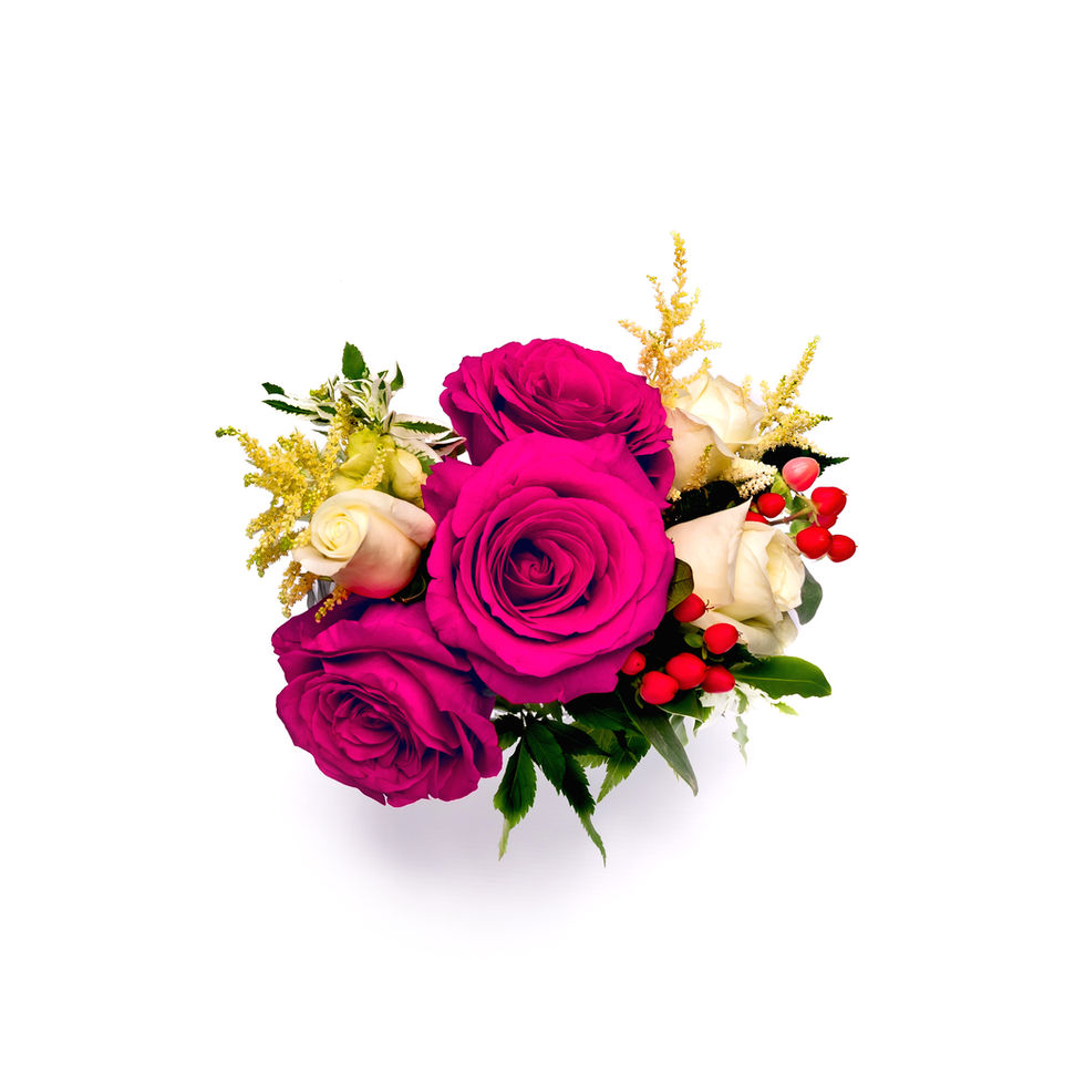 Pink and white roses with greenery and berries.