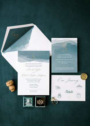 Elegant wedding invitations with blue and gold accents.