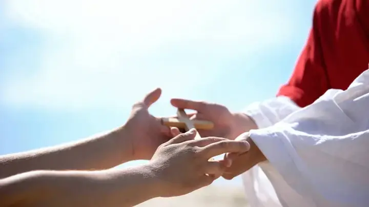 depositphotos_308905416-stock-photo-priest-hands-giving-wooden-cross.webp