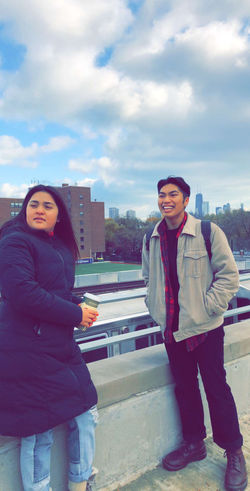 Students smiling on their college campus with the city of Chicago behind them