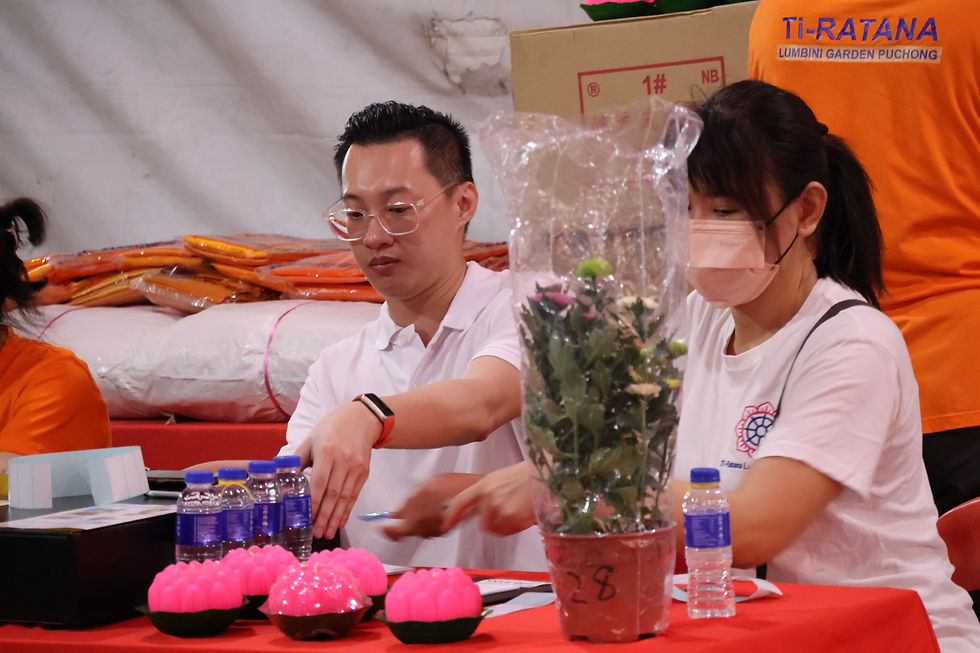 Volunteers assisting at the donation and offering counter during the Wesak Eve celebration.