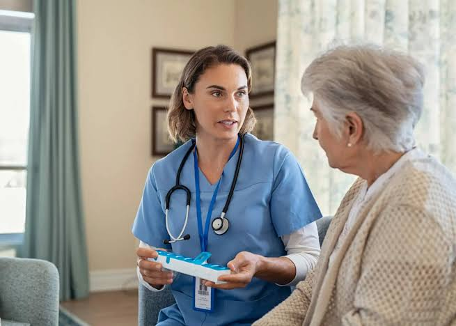 OCTIHEALTH home health nurse discussing Medicare-covered skilled nursing care with an older patient at home.