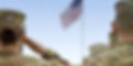 Military personnel saluting the US flag