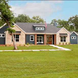 A large house with a spacious lawn in front