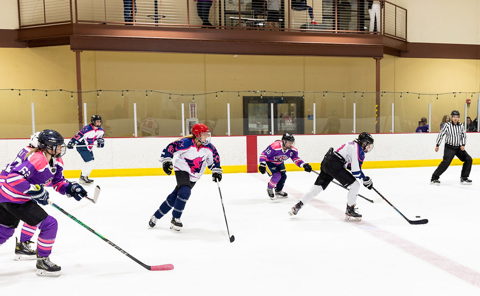 Lexine Yurco, #82, and team breakaway with the puck