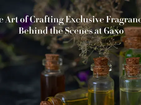 “Moody photograph of small glass perfume vials with cork stoppers, surrounded by dried flowers, representing Gaxo’s artisanal fragrance creation process.”