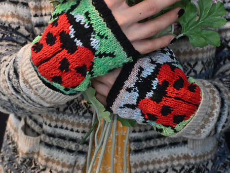 Model with Ladybug gloves holding flowers