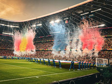 Fifa World Cup Soccer stadium full of fans, as colorful fireworks and smokers go off in the stadium on a stage 