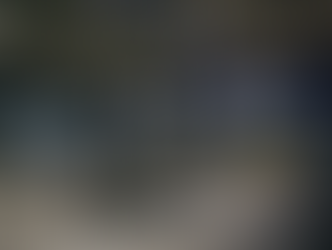 A dark gym with blue walls and work out equipment