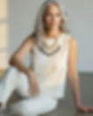 Woman with gray hair wearing a unique handmade necklace