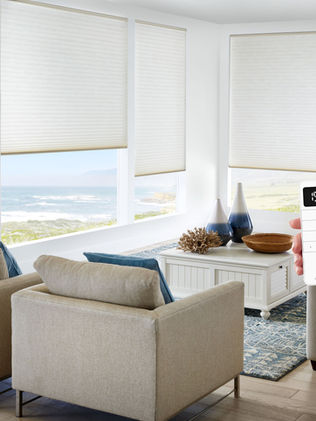 white alta honeycomb shades with motorization in living room