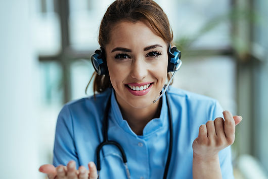 young-happy-healthcare-worker-wearing-headset-talking-with-patients-while-working-call-cen