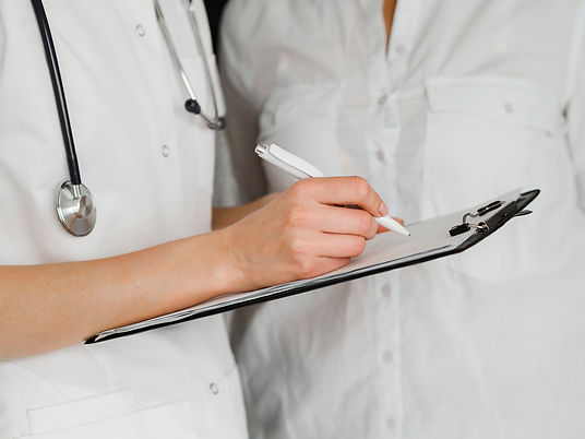 close-up-doctor-filling-document.jpg