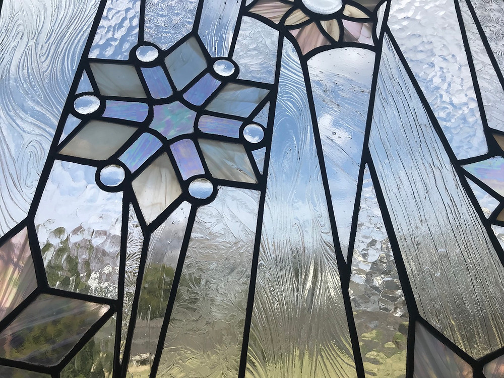 Stained glass snowflake panel by Laura Koss, owner and maker at Garden State Glasswork