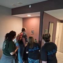 Team WNL (Within Normal Limits) looking for clues in the Escape Room.