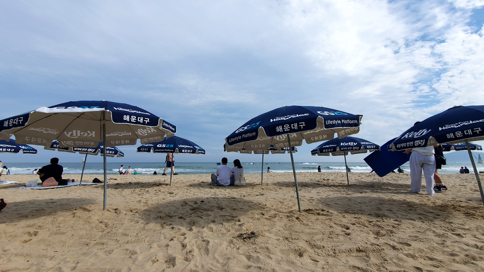 Blue GS25 parasols on the beach at Haeundae, Busan