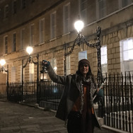 Person outside holding a lamp