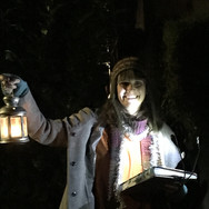 Person holding a lamp in the dark