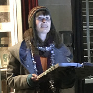 Person outside reading a story aloud in winter