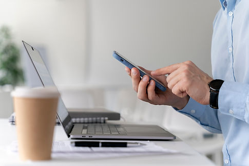 young-business-man-working-her-desk-with-laptop-smartphone.jpg