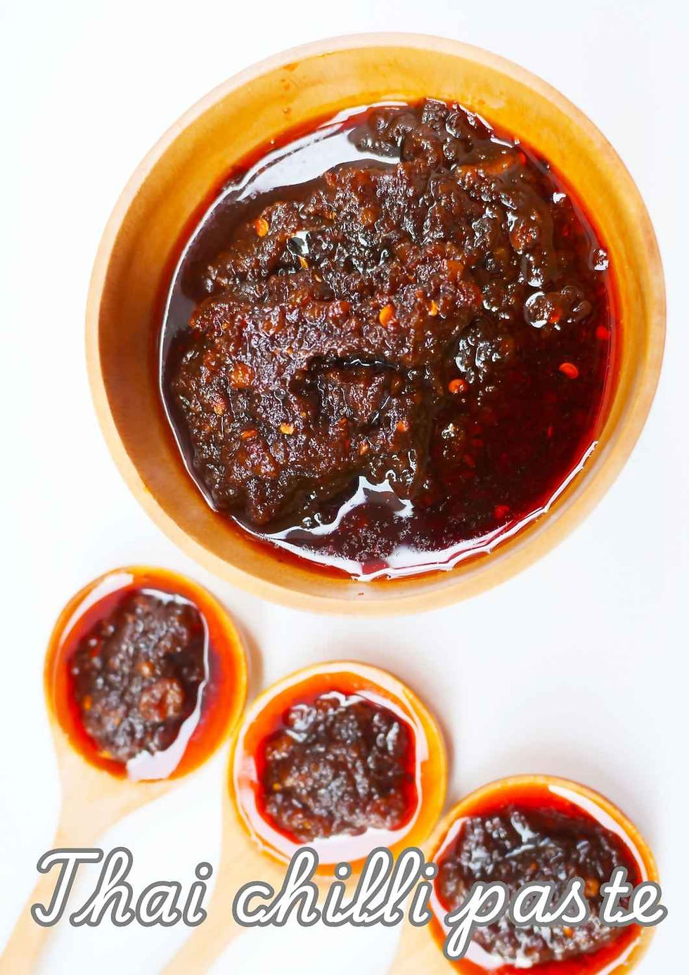 Jar of Nam Prik Pao, traditional Thai chilli paste made with roasted chilies, shallots, garlic, shrimp paste and tamarind.