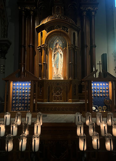 Prayer candles and relics at a shrine to St. Mary