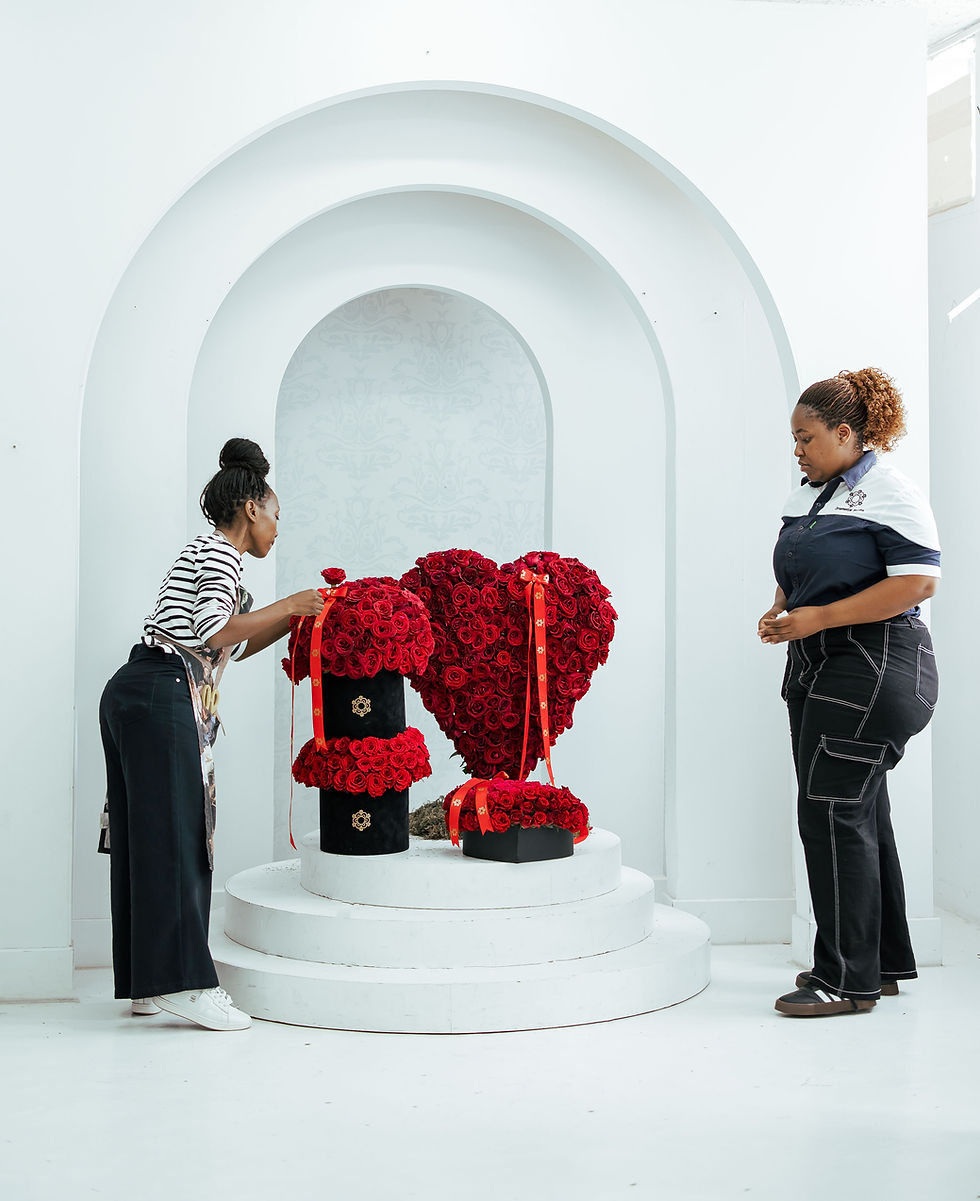 two team members setting up floral arrangements