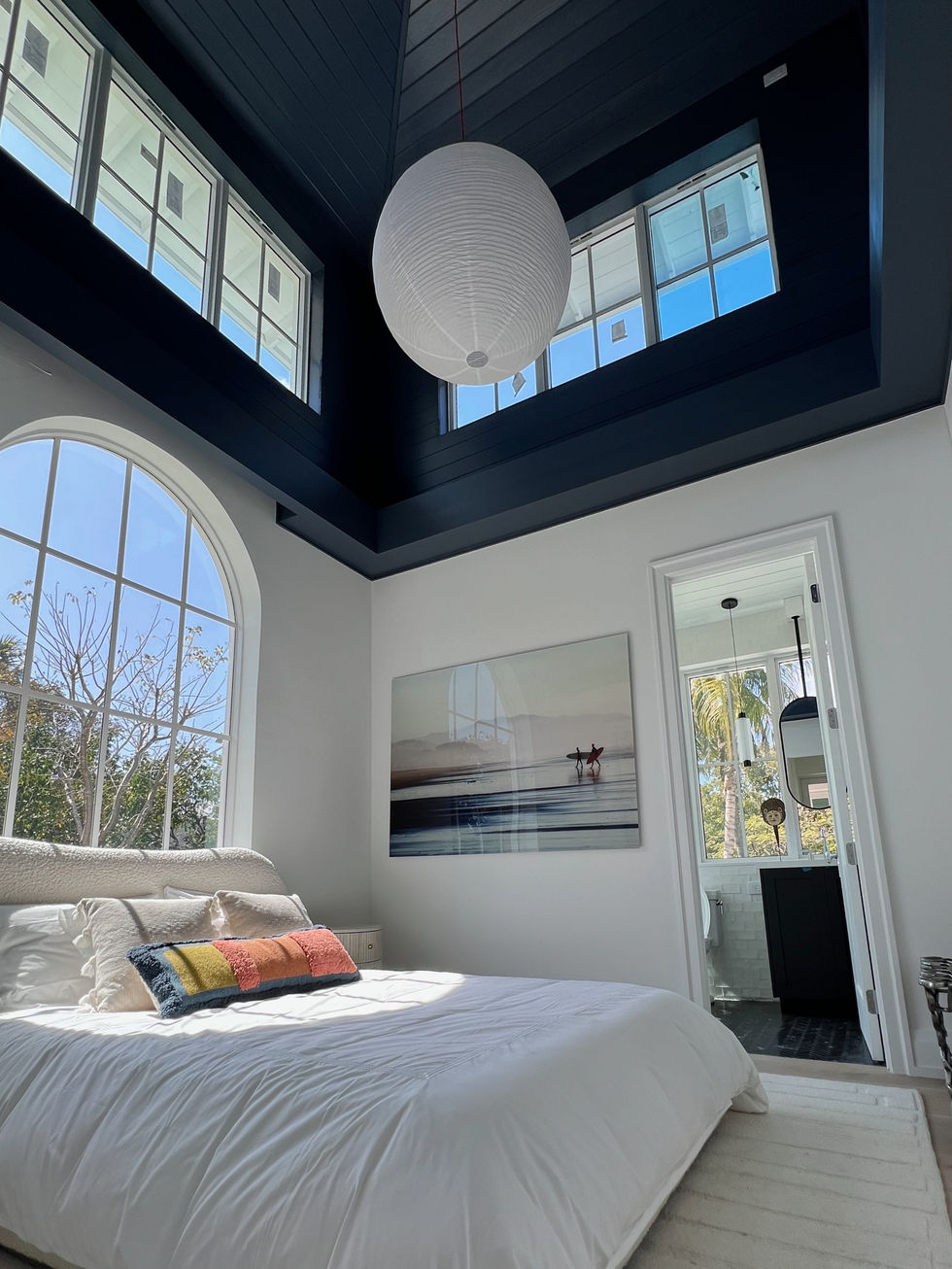 a bedroom with a bed and a painting on the wall