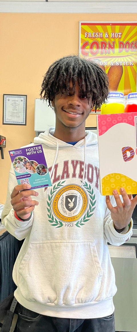 Employee holding up treats and TFC sign