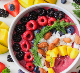 A vibrant smoothie bowl topped with fresh fruits and nuts.