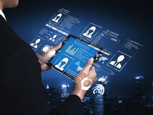 Businessman using a tablet with floating profile dashboards and labels like ACCESS GRANTED over a night city skyline.