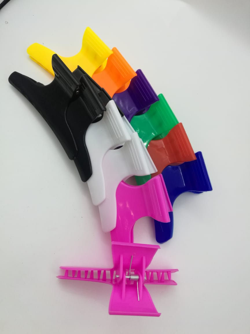 Pinza de plastico para peluqueria 9cm. Paquete de 12piezas