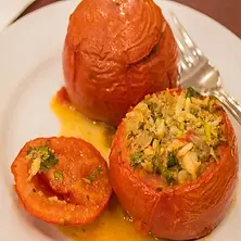 Tomatoes stuffed with rice, herbs, and spices, baked to perfection.