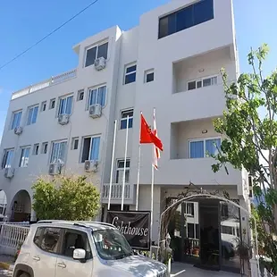 Light House Hotel coastal terrace with panoramic sea views and evening lights.