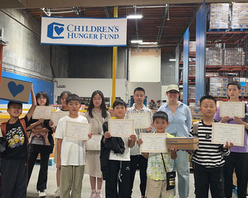 Children's Hunger Fund volunteers holding certificates