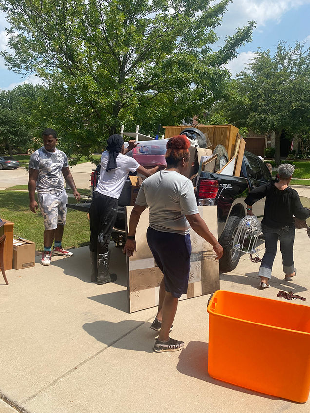 StrongStart team unloading a truck full of household donations