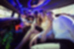 Happy friends chatting in limousine on a night out.jpg