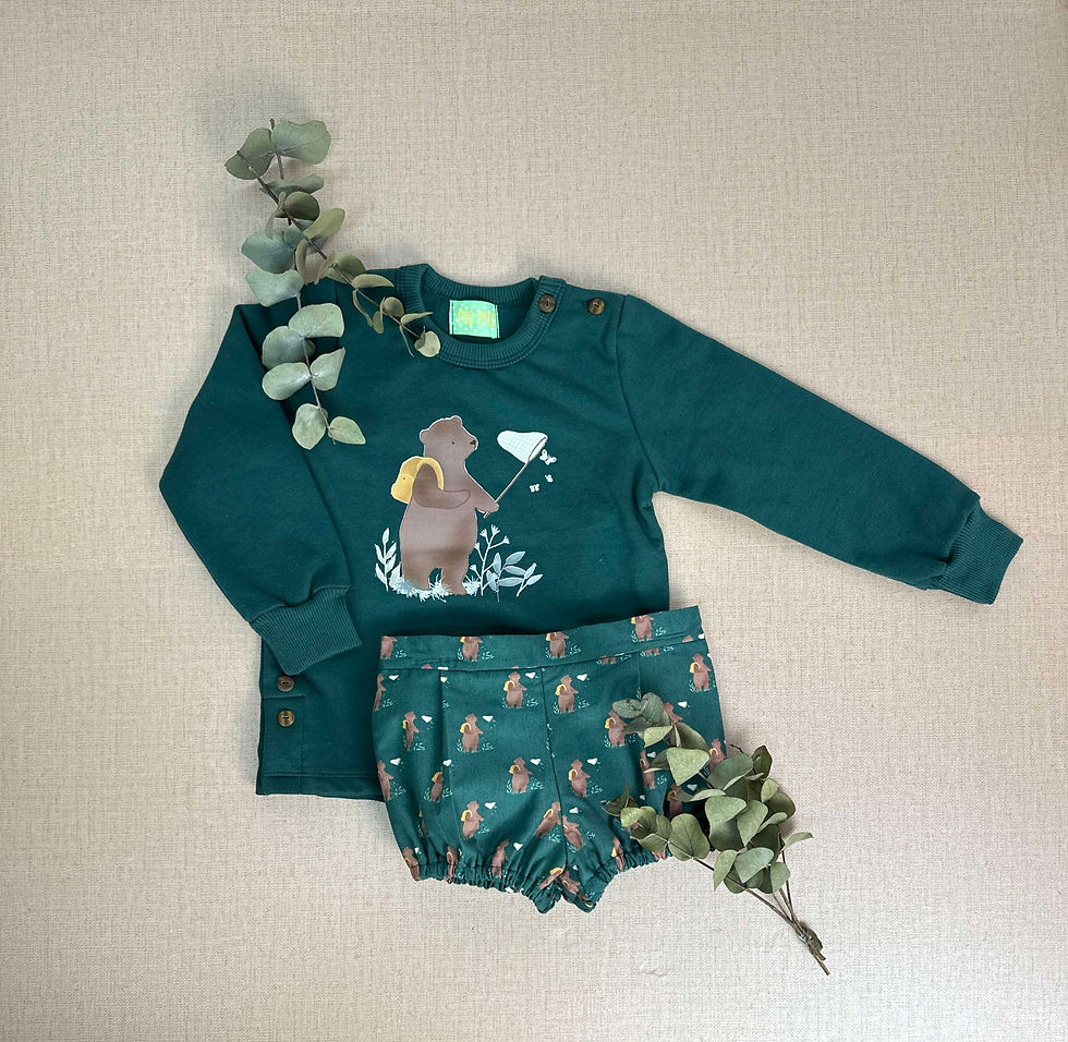 Conjunto compuesto por sudadera de felpa verde botella con dibujo de oso en tonos tierra y bombacho en tela mismo tono