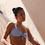 Thumbnail: side view of model wearing halter neck bikini top with front tie centre