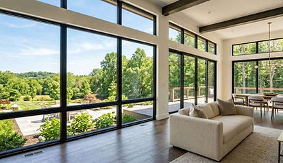 Modern commercial office interior with expansive floor-to-ceiling windows enhanced by commercial window tinting in Radcliff, KY by Sun Tint, improving energy efficiency, glare reduction, and natural light.
