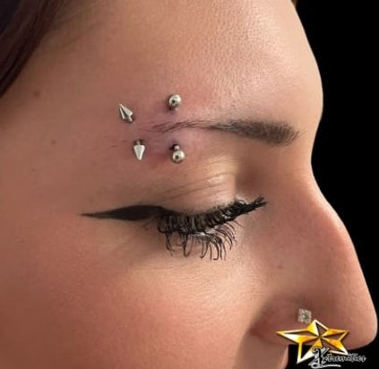 Vertical Eyebrow Piercing With Mixed Stud and Spike Ends.jpg