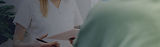 Caregiver taking notes during a care consultation