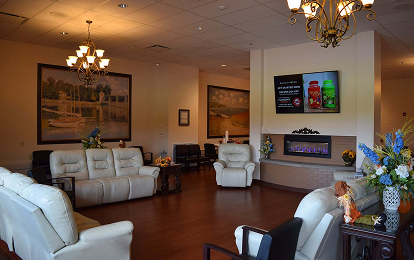 Chapel sitting area with white sofas and chandelier