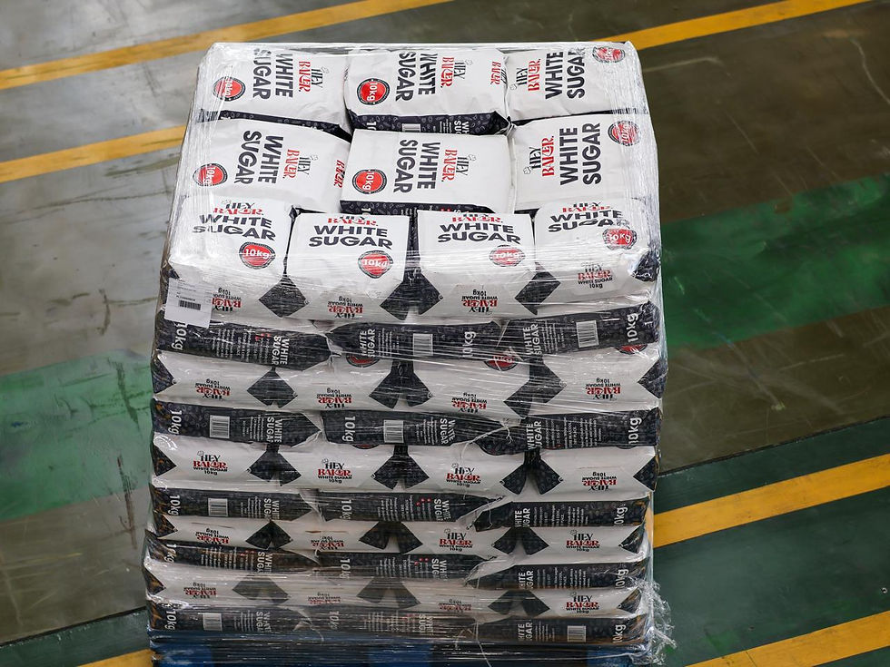 Eye-level view of sugar bags stacked in a warehouse ready for delivery