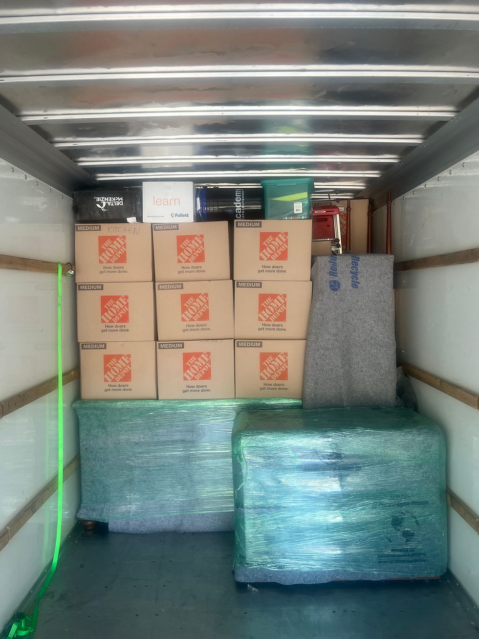 Chris Moving LLC truck filled with neatly packed moving boxes, ready for transport.