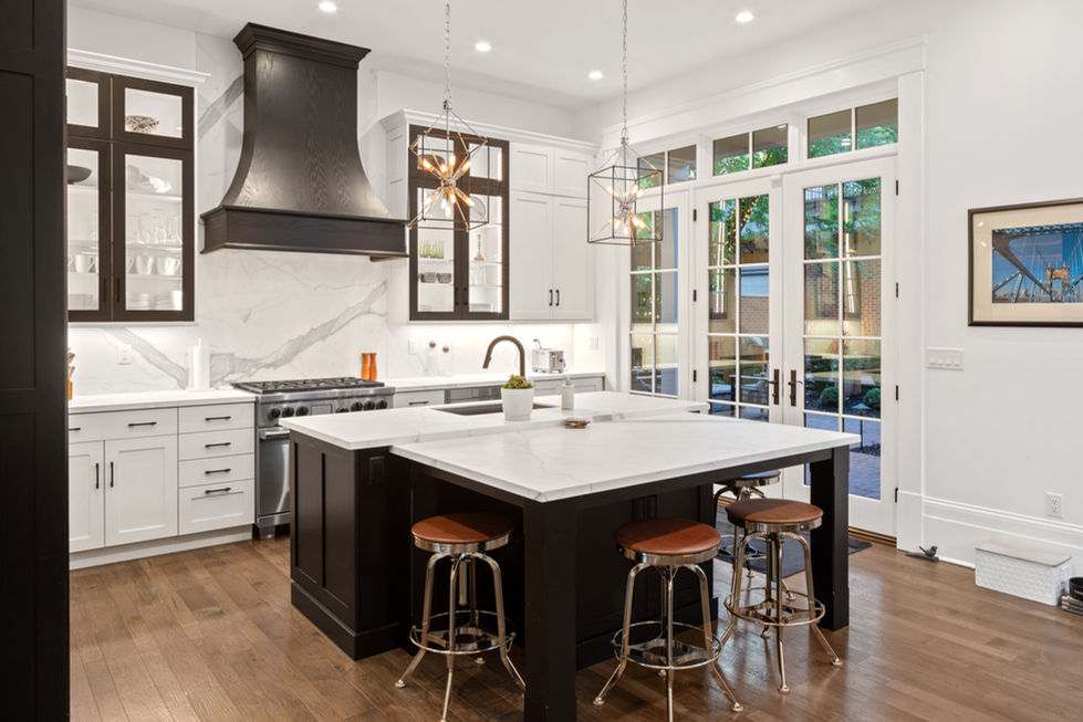 Modern kitchen with island and stools.
