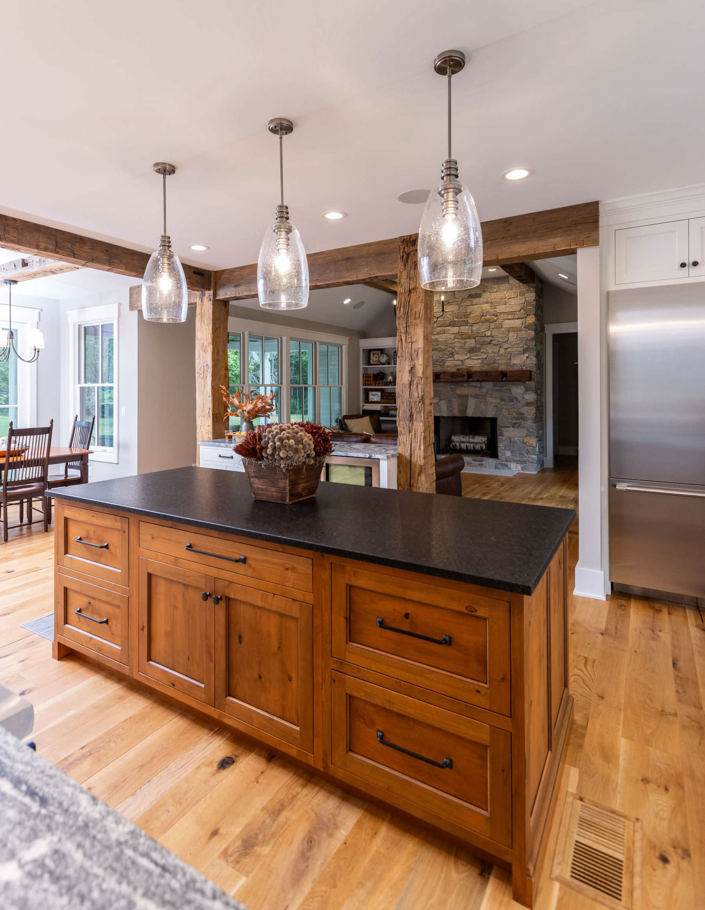 Kitchen with wooden island and hanging pendant lights.