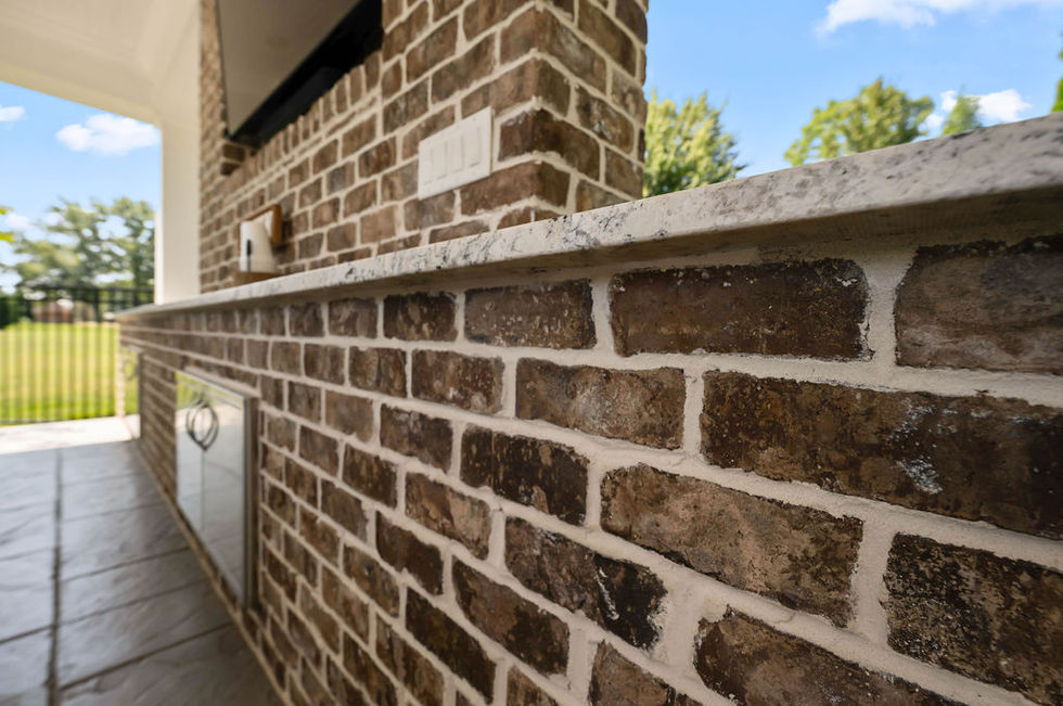Close-up of brick wall with countertop edge.