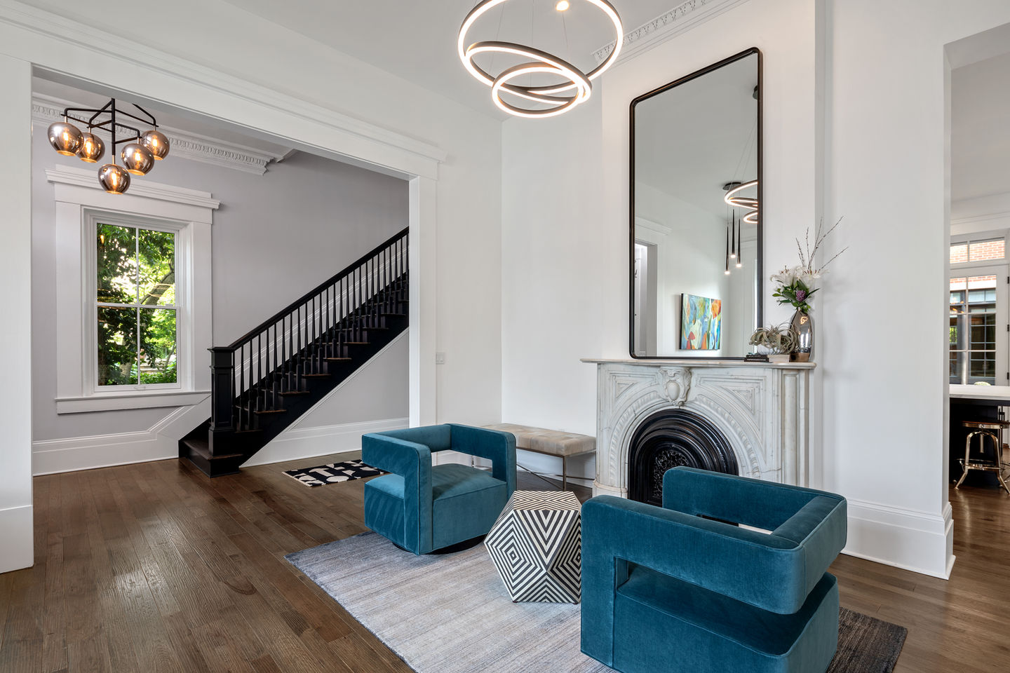 Modern living room with blue chairs and geometric table.
