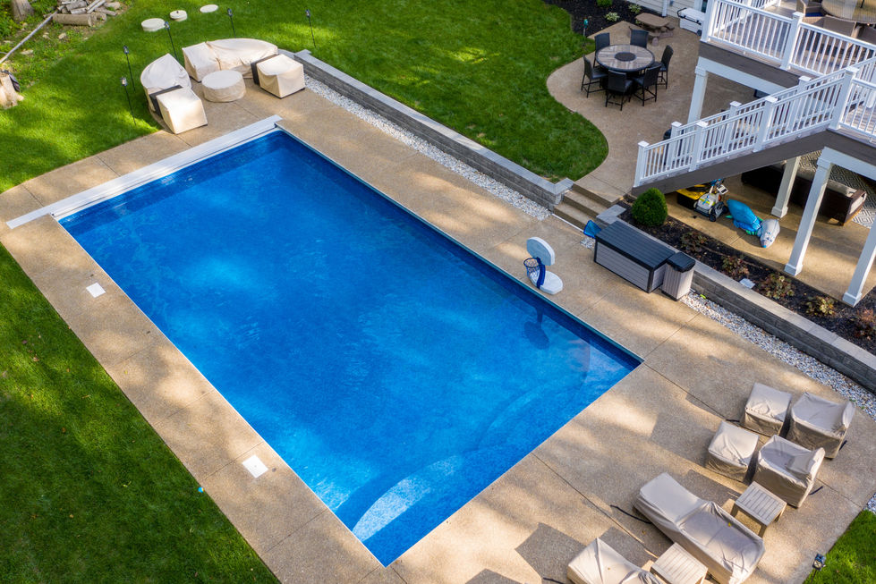 Rectangular swimming pool in a backyard setting.